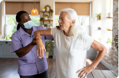 caregiver offering exercise support to a senior, highlighting the importance of physical activity