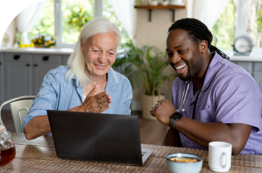 caregiver assisting an elderly woman in companion care services