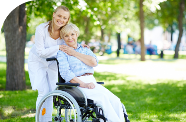 caregiver assisting old woman seated on wheelchair in alzheimer dementia services