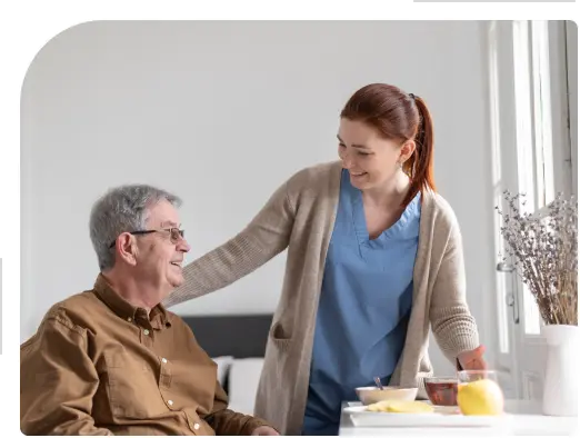 a lady home caregiver assists an elderly man